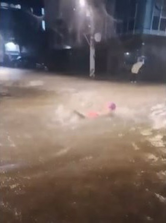 Seorang pria berenang di jalan yang dibanjiri hujan lebat... Kritik seperti "Saya khawatir tentang sengatan listrik", "Apakah tidak apa-apa untuk penyakit kulit" = Korea Selatan